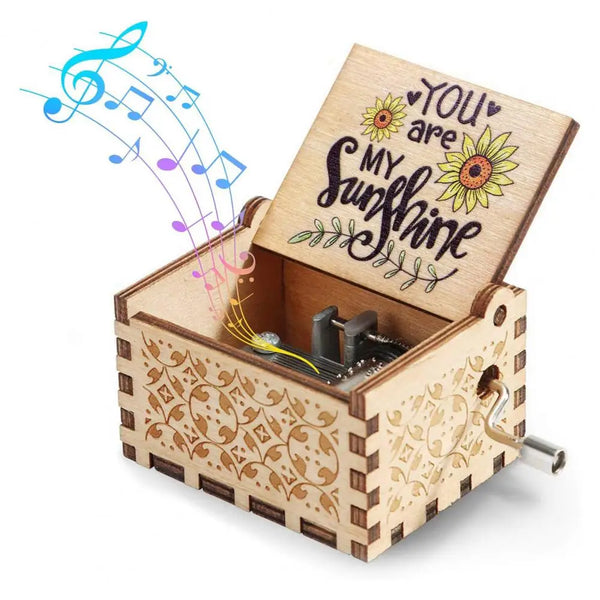 A small wooden music box with a lid open, featuring a hand-crank mechanism and a floral design.