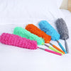 A collection of colorful telescopic electrostatic microfiber dusters with extendable stainless steel handles displayed on a w