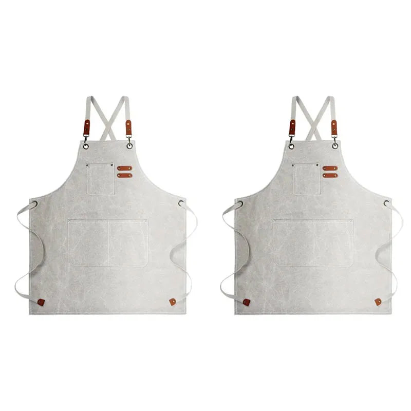 A light gray oil-proof canvas apron with utility pockets and adjustable straps.
