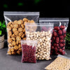 Varias bolsas ziplock transparentes llenas de semillas y granos secos como semillas de calabaza, lino y frijoles rojos