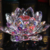 A clear crystal lotus flower centerpiece with pink and purple facets displayed on a dark surface.
