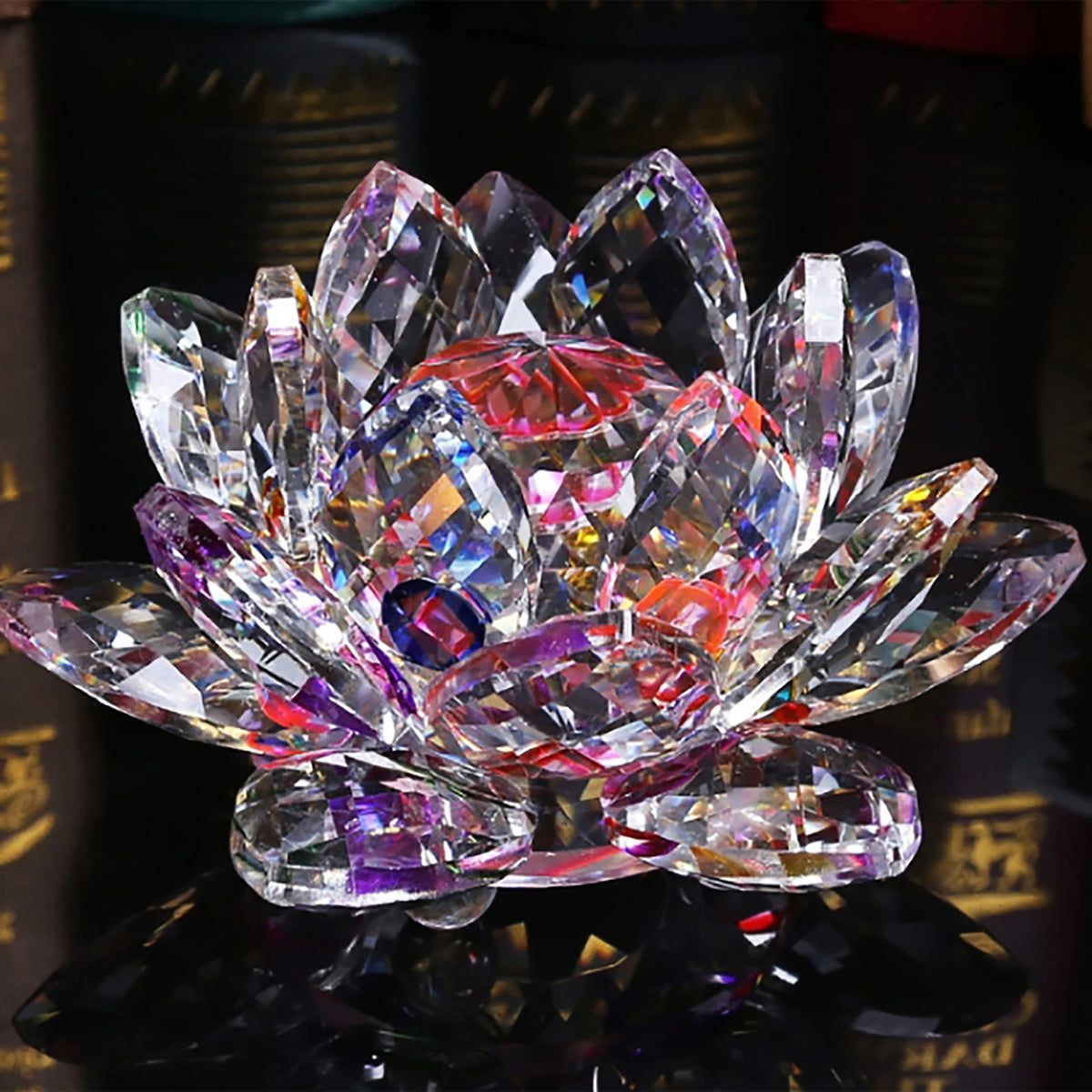 A clear crystal lotus flower centerpiece with pink and purple facets displayed on a dark surface.