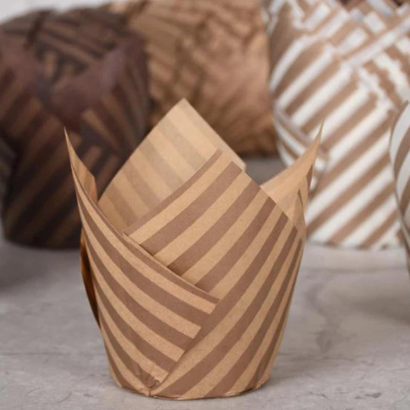 A stack of brown paper cupcake liners with striped patterns.