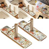 A set of natural diatomaceous earth faucet mats with modern metal handles and floral patterns.