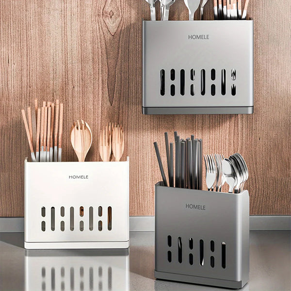 Three modern cutlery storage racks in silver and white metal displayed against a wooden background.