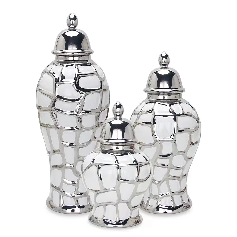 Silver ceramic flower vase with a textured, geometric pattern, shown in three views.