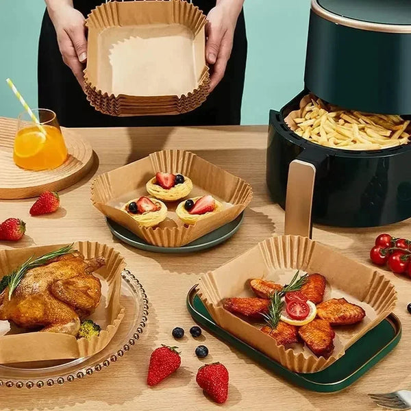 A set of disposable non-stick air fryer parchment liners is shown with food items and fresh berries on a wooden table.