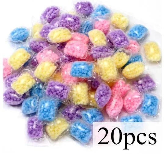 A collection of colorful laundry fragrance beads in various shades of purple, blue, and yellow.