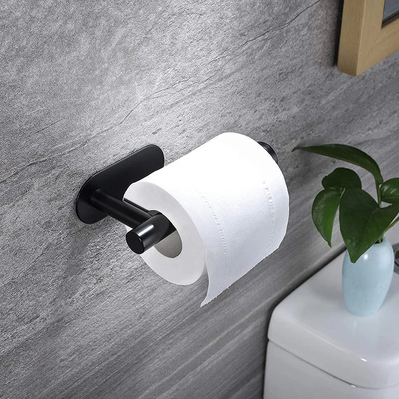 A black stainless steel adhesive paper dispenser rack mounted on a gray wall, holding a roll of white paper.