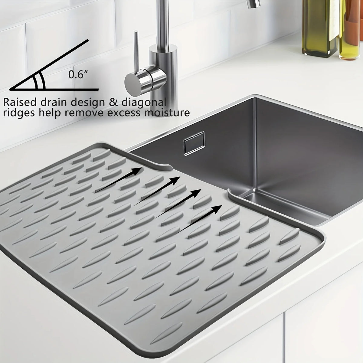 A silicone dish drying mat with raised drainage ridges is shown next to a kitchen sink.