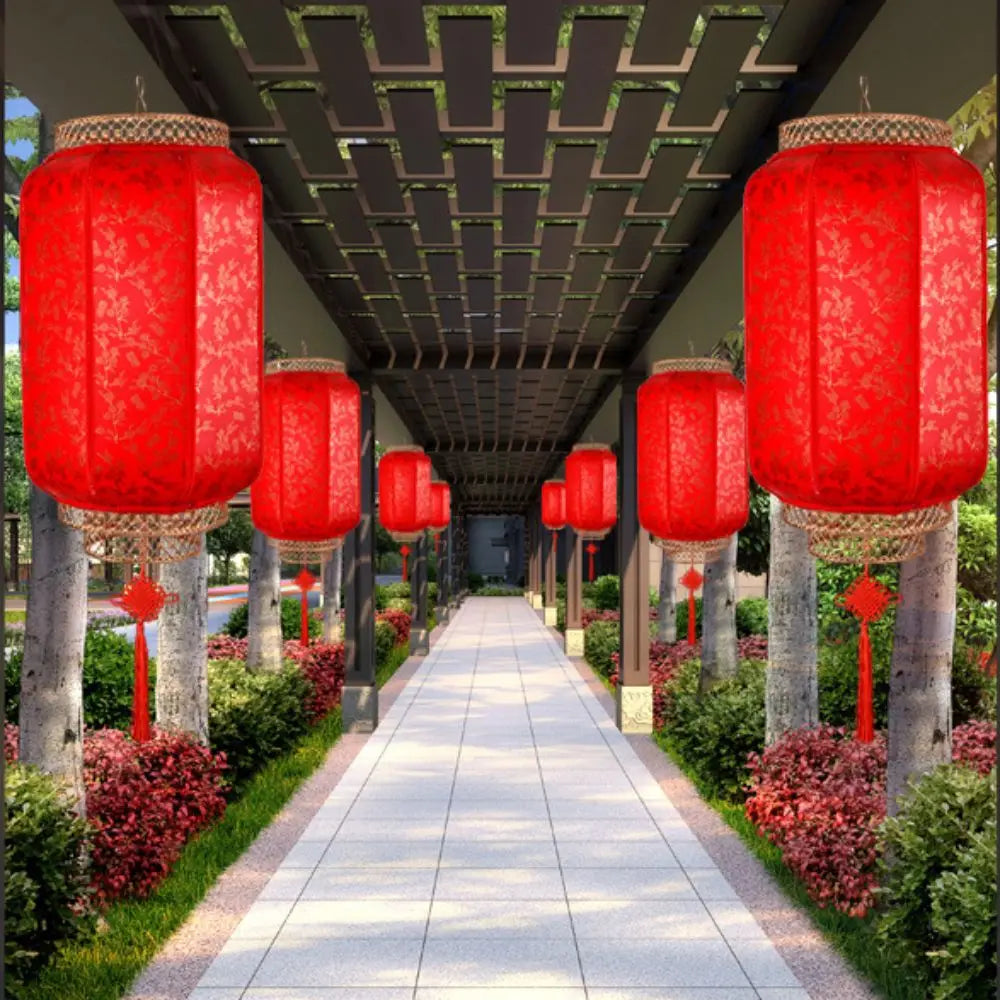 A row of large, vibrant red Chinese lanterns hanging from a pergola line a pathway surrounded by greenery.