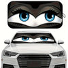 Close-up of a cartoon folding car sunshade windshield protector featuring blue eyes.
