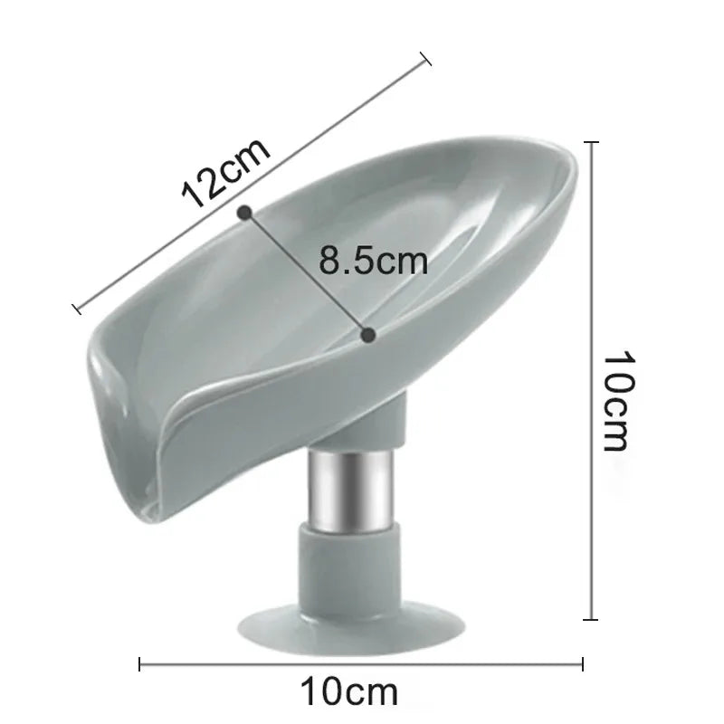 A gray leaf-shaped suction cup soap holder with a self-draining tray and a cylindrical base.