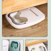A white foldable foot soak bucket with a contoured insert is shown next to a toilet and on a wooden surface.