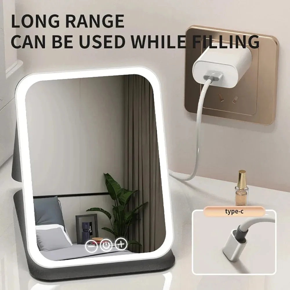 A portable touch screen vanity mirror with adjustable LED lights is shown next to a wall outlet.