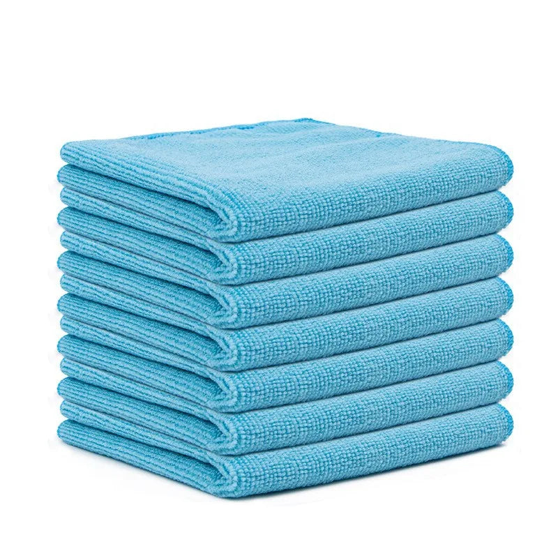 A stack of ten light blue reusable microfiber cleaning cloths.