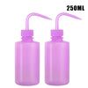 A pair of purple squeeze bottles with measurement marks for tattoo solutions.