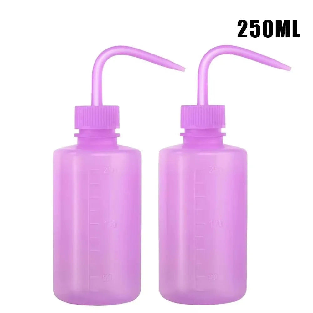 A pair of purple squeeze bottles with measurement marks for tattoo solutions.
