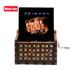 Antique wooden hand crank music box with a black display showing the word FRIENDS