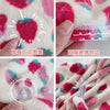 Close-up of a pink and white strawberry print quick-drying hair towel headscarf being packaged.