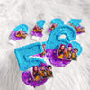 A collection of six blue and purple glitter candles shaped like the number 6 on a white fluffy surface.