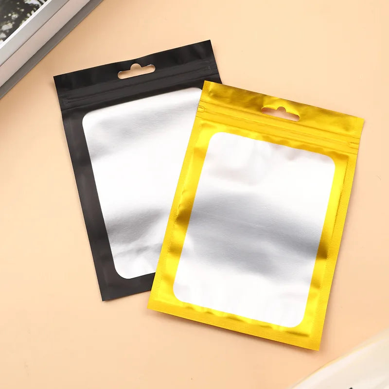 A set of two jewelry display pouches, one black and one gold, are shown against a light background.