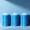 Three stacked blue foam toilet brushes with white handles against a light blue background.