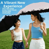 A woman holds a black umbrella with a golden curved handle, featuring a vibrant new experience promotion.