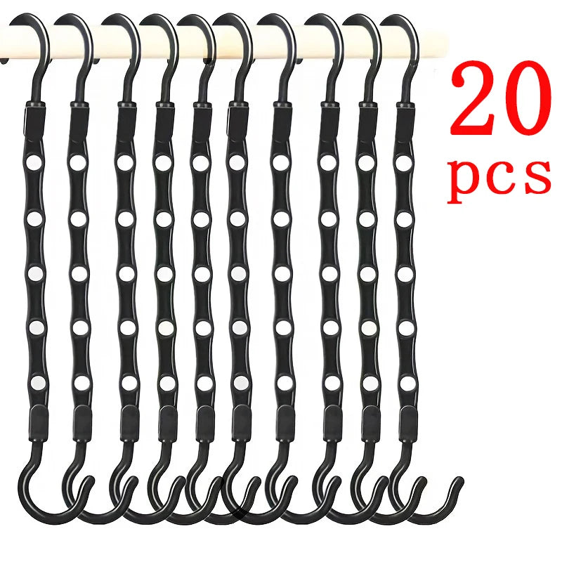 A pack of 20 black plastic clothes hangers for closet organization.