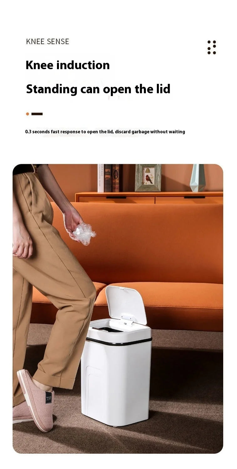 A person is using a knee induction sensor to open the lid of a white touchless trash can.