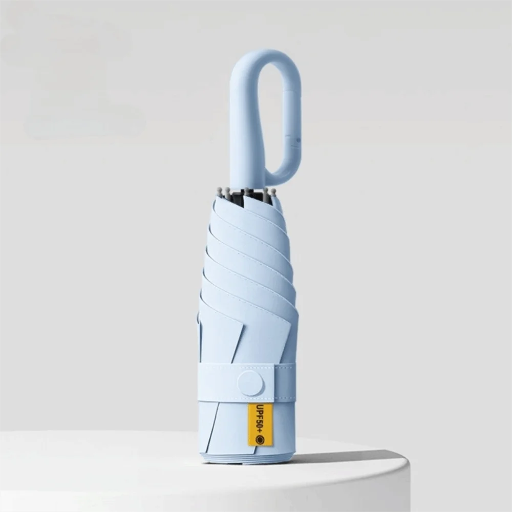 A light blue compact folding umbrella with a curved handle and protective casing.