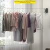 A clothesline with hangers displaying various garments, showing the rope after adjustment and drying.