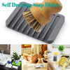 A set of two bamboo dish scrubbing brushes with sisal bristles resting on a gray silicone dish drying mat.