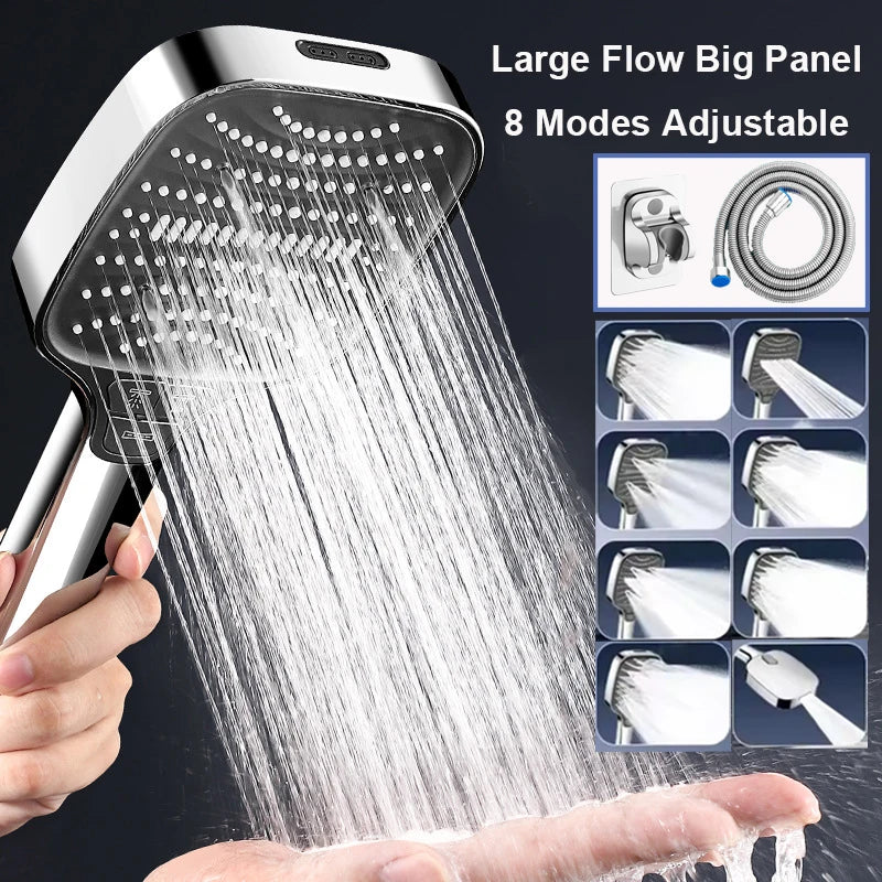 A hand is holding a large flow big panel handheld shower head spraying water onto a palm.