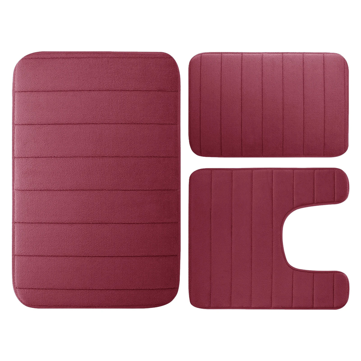 Ein Set aus drei rechteckigen Memory-Foam-Badematten in pudriger Rosatfarbe.