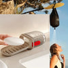 A hand holds a silver leakproof portable soap dish for travel and kitchen use.
