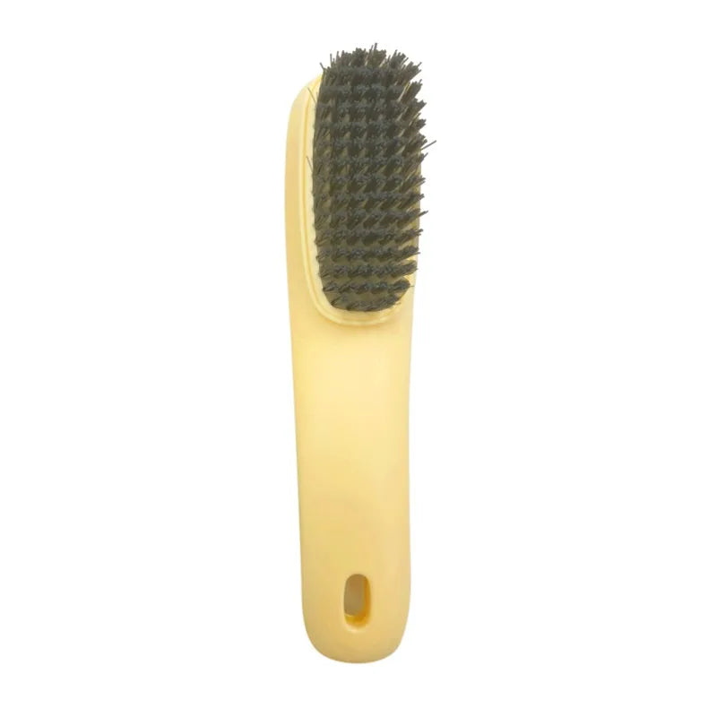 Brosse multifonction jaune pour nettoyer des chaussures et des vêtements, avec une tête à poils.