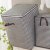 A patterned fabric foldable clothing storage bag is shown next to an open version.
