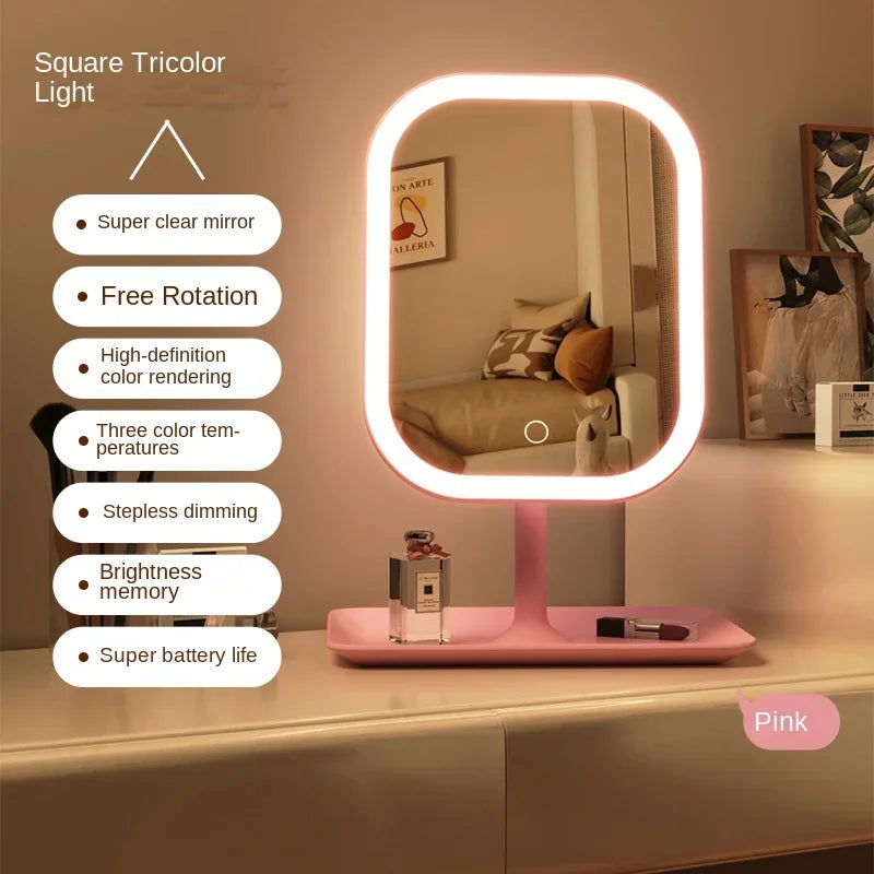 A pink LED desktop vanity mirror with a circular light frame is shown on a white surface.