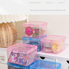 Clear plastic storage boxes for jewelry and small items in pink, purple, and blue colors