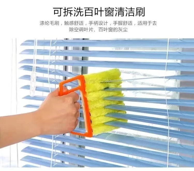 An orange cleaning brush is shown cleaning the slats of a blue horizontal blind.