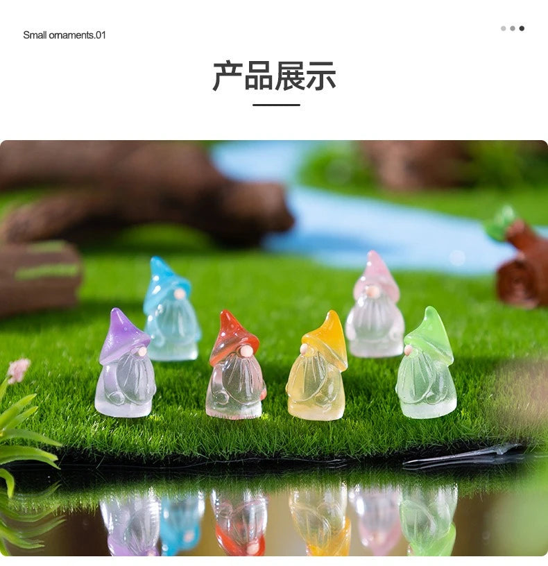 A collection of luminous resin mini fairy gnomes in various pastel colors displayed on green grass.