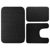 A set of three black memory foam bathroom rugs, including a rectangular mat and two curved mats.