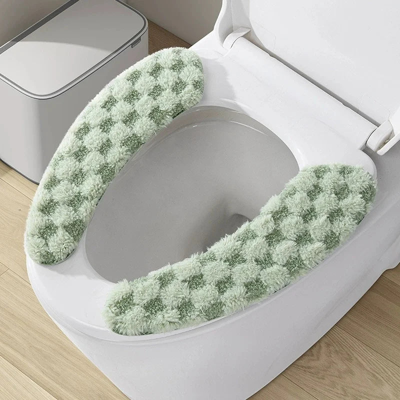 A toilet seat cushion cover with a green textured fabric is shown inside a white toilet bowl.