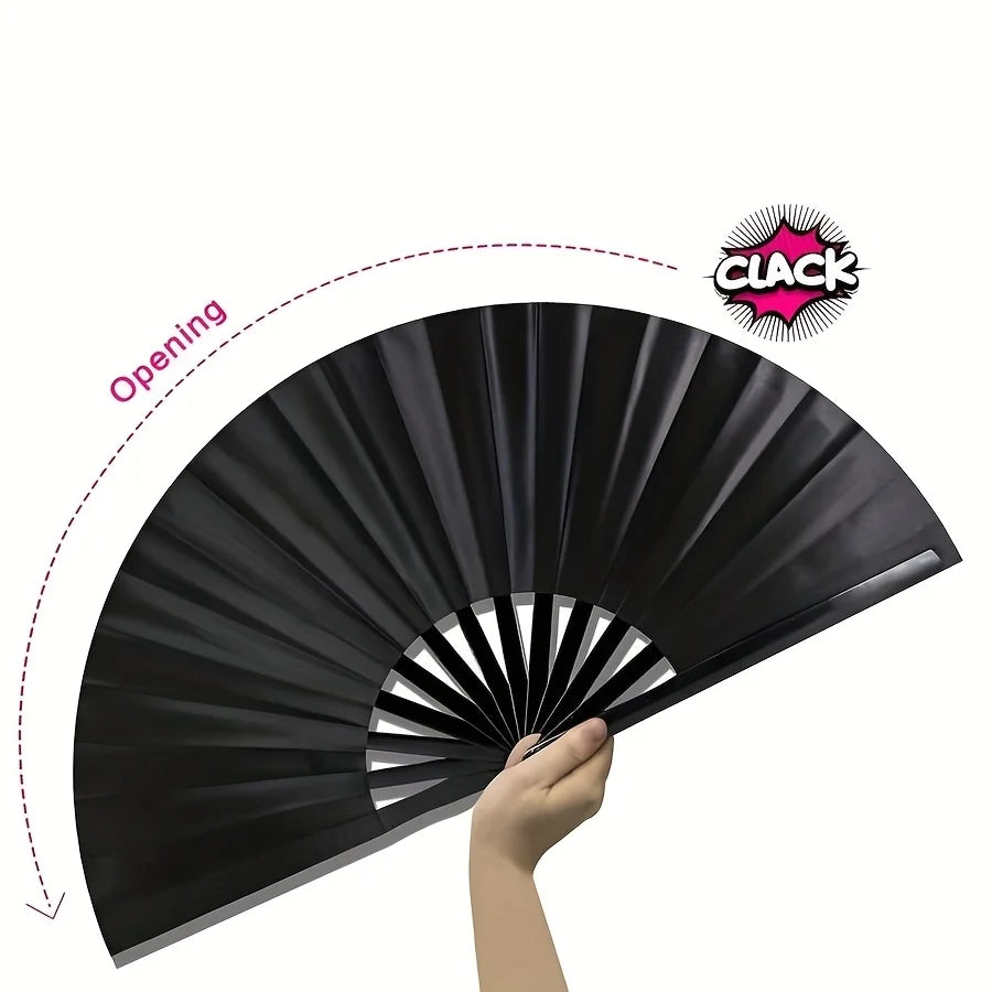 A hand is opening a black folding fan, revealing its pleated design.