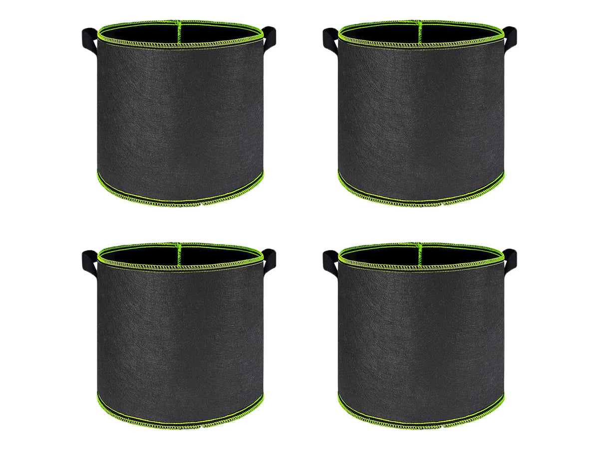 A set of black breathable fabric plant grow bags with green trim and sturdy handles.