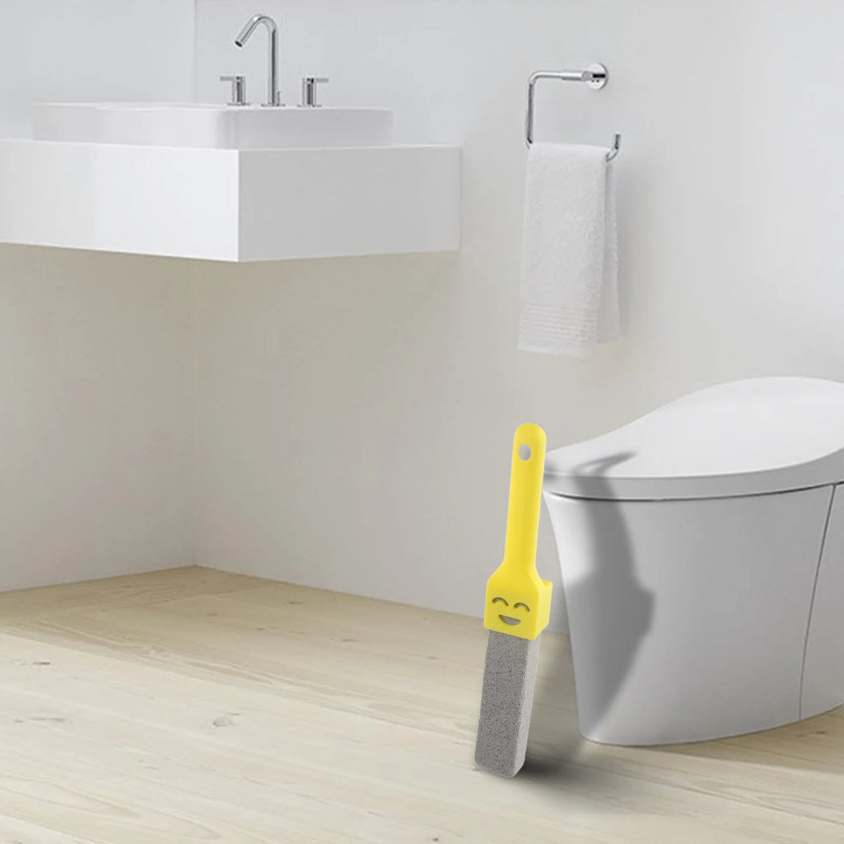 A yellow natural pumice toilet cleaning brush with a handle is shown next to a white toilet bowl and sink area.