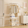 A white metal coat rack with wooden hangers and storage boxes is displayed against a light beige wall.