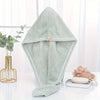 A light mint green microfiber hair drying wrap towel displayed on a white surface.