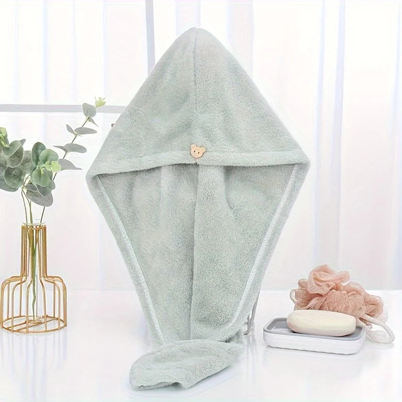 A light mint green microfiber hair drying wrap towel displayed on a white surface.